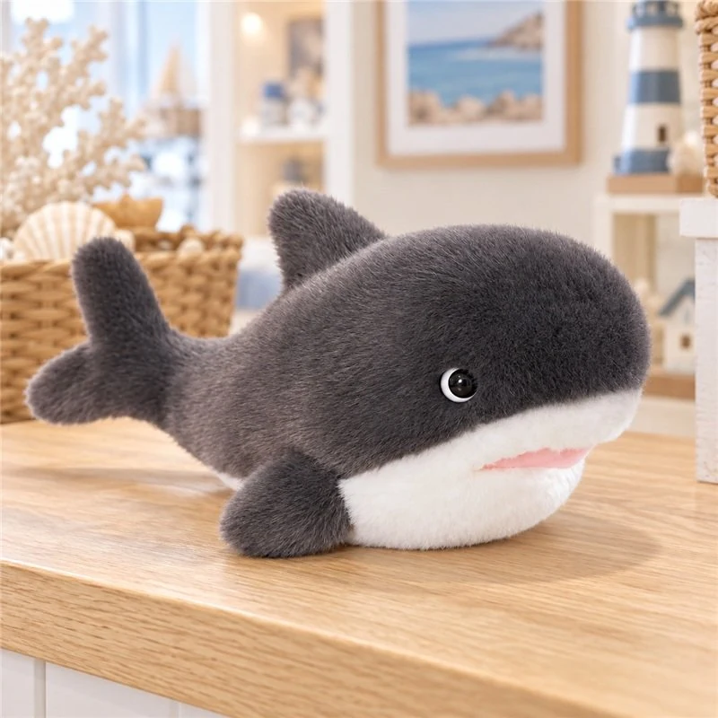 Illustrative application scene featuring smiling stubby gray shark plush; setting is a concept.