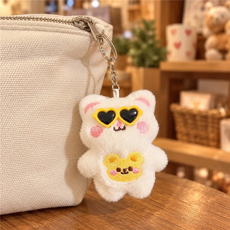 Illustrative application scene featuring heart sunglasses white bear plush keychain; setting is a concept.